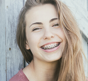 Young teen with braces smiling